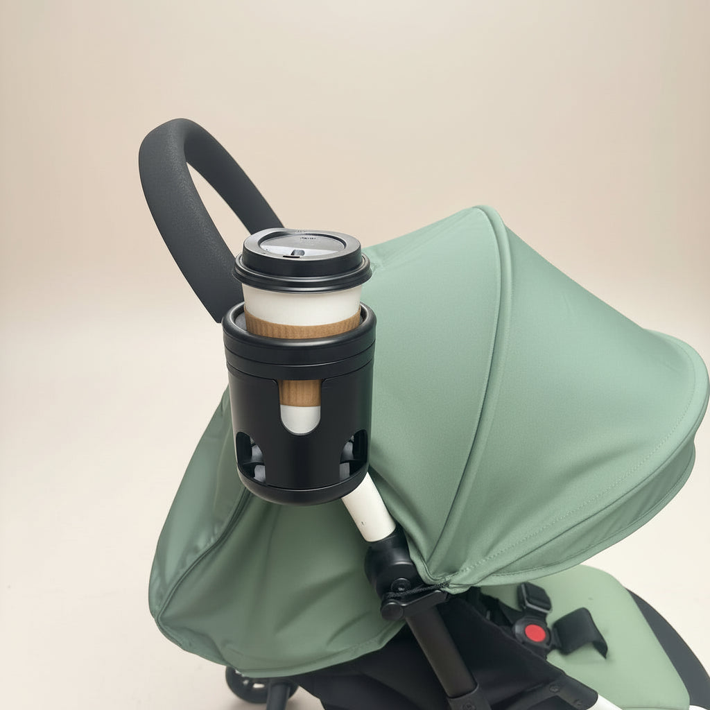 Green stroller with a black cup holder on a beige background