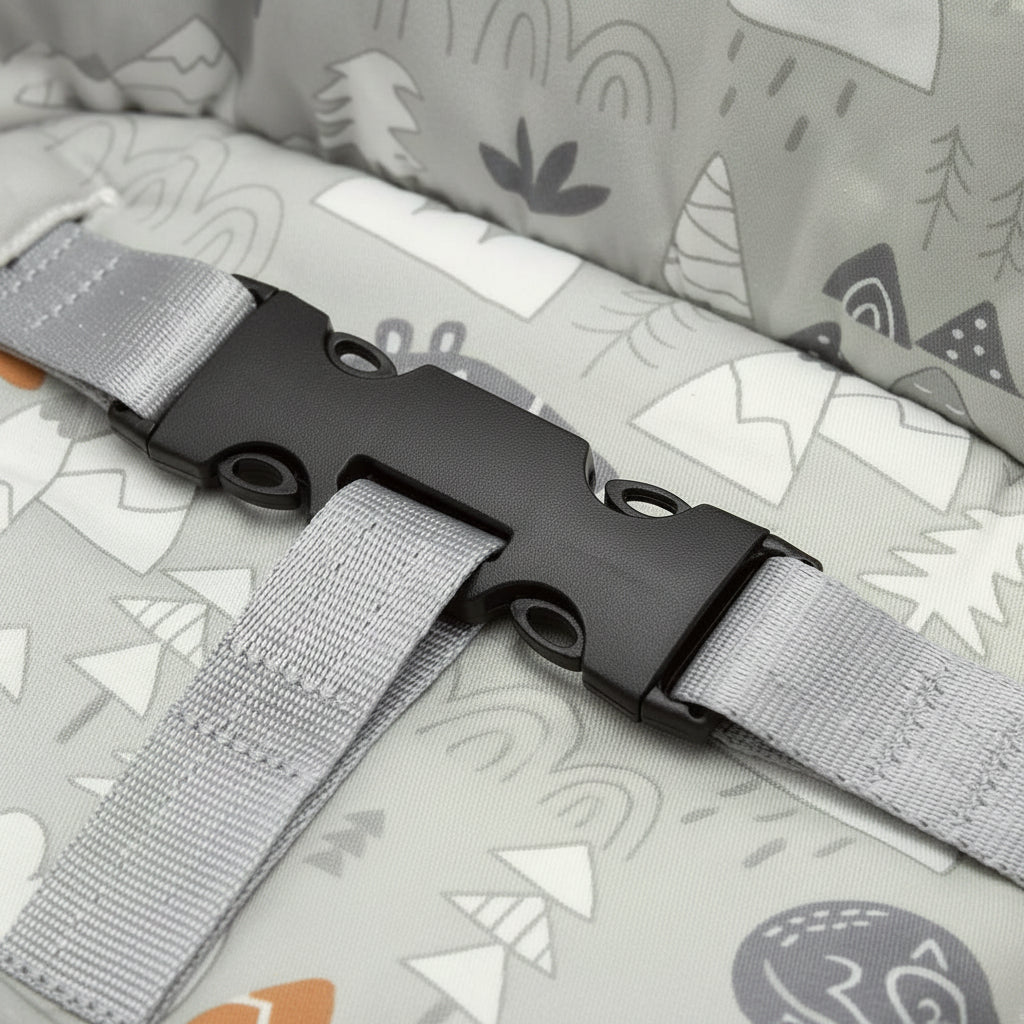Gray strap with black buckle on a grey fabric background with nature-themed patterns