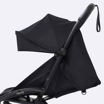 Black stroller with canopy on a white background