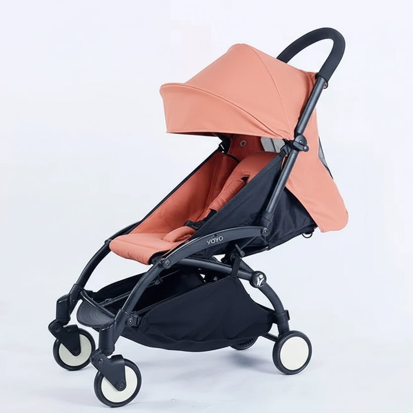 Black and ginger pink stroller on a white background