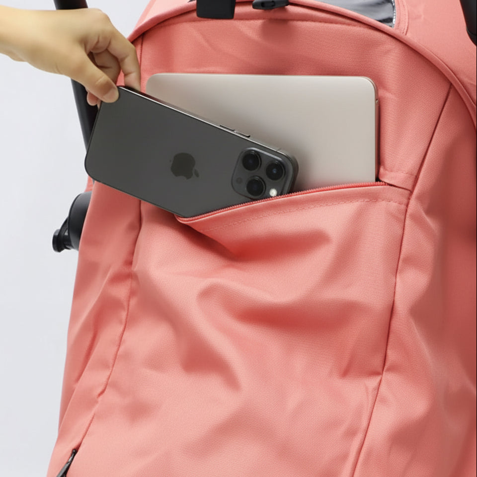 Pink pram with a phone and laptop in a pocket on a light gray background