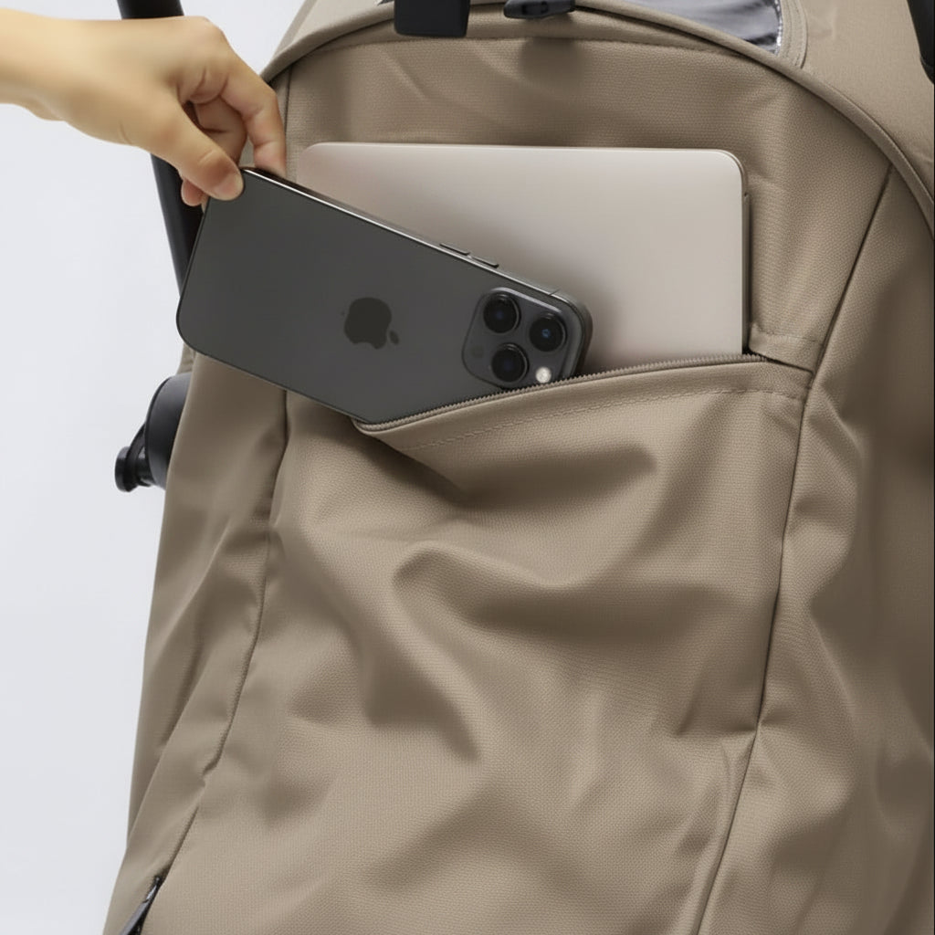 Person placing a phone and laptop into a toffee pram pocket.