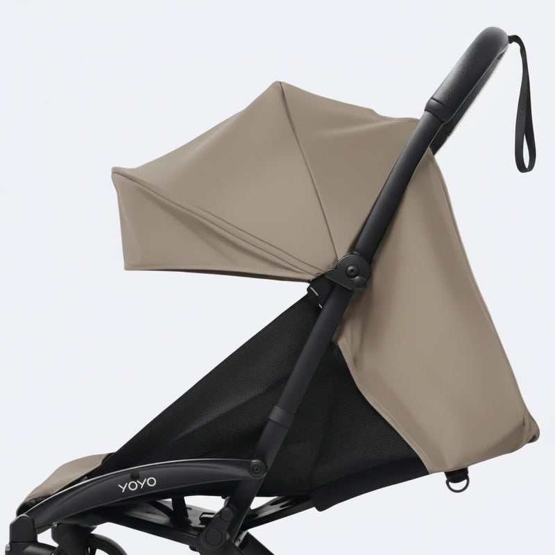 Baby stroller with a toffee canopy on a white background